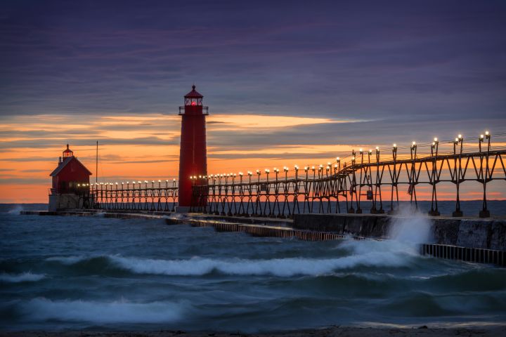 Photo of a pier and lighthouse in sunset